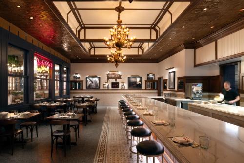 a restaurant with a long bar with tables and chairs at Durango Casino & Resort in Las Vegas