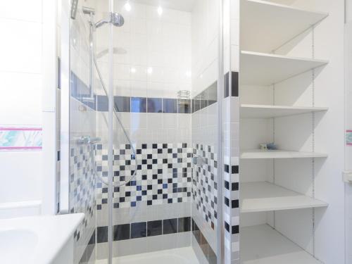 a white bathroom with a shower and a black and white tiles at Appartement 4 Pers. Terrasse Clim, Piscine Collective - FR-1-535-37 in Châtelaillon-Plage