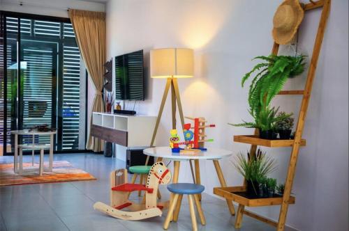 a room with chairs and a table and a lamp at Enjoy Samui Residences Pause by Replay in Koh Samui 