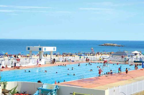 a group of people in a swimming pool near the ocean at Spacious Oceanview Villa (Sleeps 22) in New London
