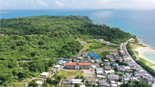 an aerial view of a village on a hill next to the ocean at LivingAnywhere Commons Uruma Male Dormitory bunk bed - Vacation STAY 15526v in Uruma