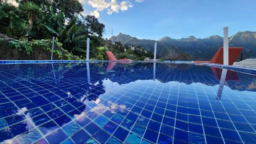 a swimming pool with a view of the mountains at DUBAI by luxury Atitlan in San Pedro La Laguna