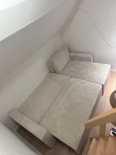 a small bed in the corner of a room at Appartement cocooning 