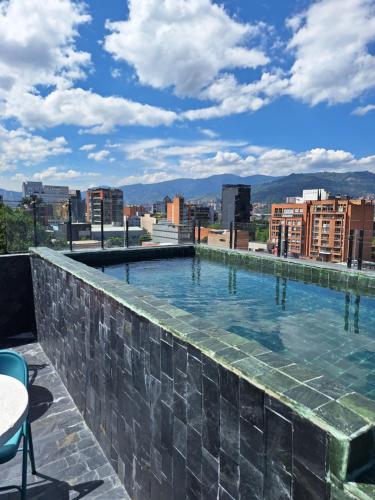 a swimming pool on the roof of a building at Hotel Zelva Negra in Medellín