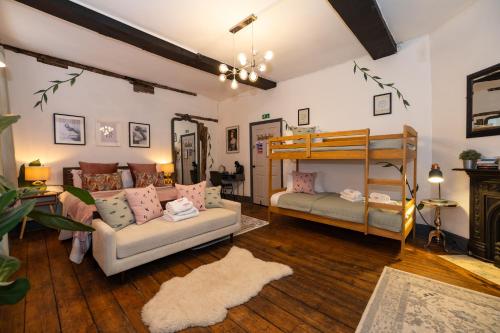 a living room with a bunk bed and a couch at RiizeRooms - self check in boutique hotel in Worcester