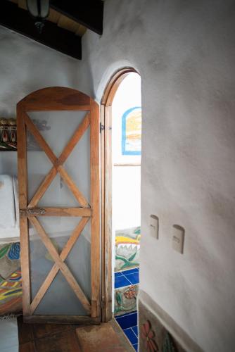 an open door to a room with a bed at Sueño del Mar Beachfront Hotel in Tamarindo