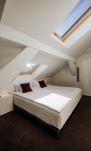 a bedroom with a large white bed in a attic at Platinum Palace Boutique Hotel & SPA in Wrocław