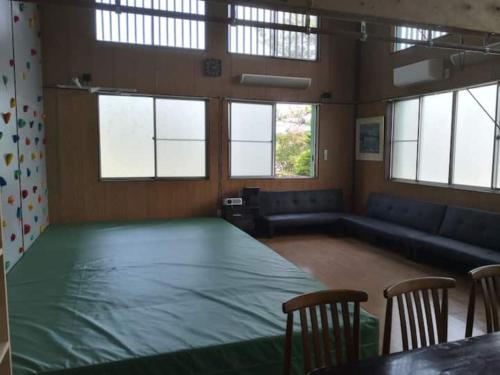 a large room with a large green table and chairs at Bouldering & SPA -Ariki Resort Shuzenji ANNEX- - Vacation STAY 07698v in Izu