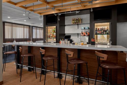 a bar in a restaurant with bar stools at Courtyard by Marriott Cypress Anaheim / Orange County in Cypress