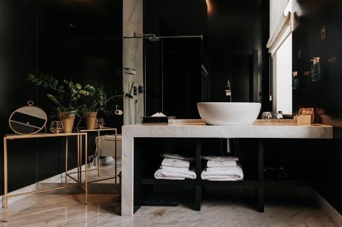 a bathroom with a sink and a counter with towels at Platinum Palace Boutique Hotel & SPA in Wrocław