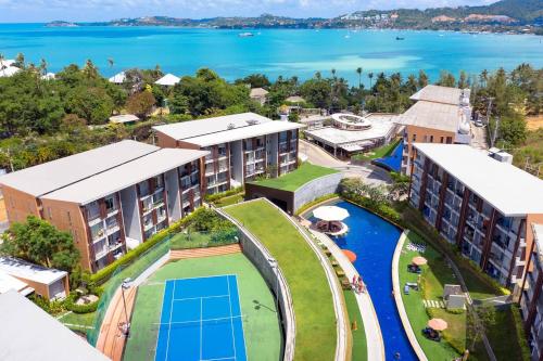 an aerial view of a resort with a tennis court at Enjoy Samui Residences Pause by Replay in Koh Samui 