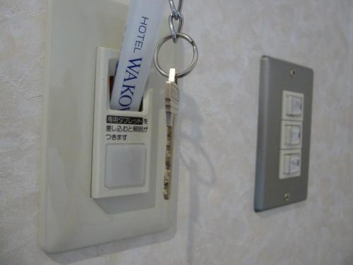 a key chain with a tube of toothpaste and a thermometer at Hotel Wakow - Vacation STAY 22127v in Yonago