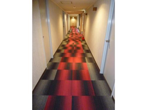 a long hallway with red and black checkered floors at Hotel Wakow - Vacation STAY 22127v in Yonago