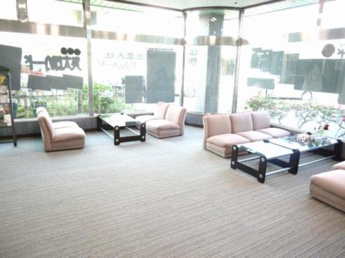 a lobby with couches and tables in a building at Hotel Wakow - Vacation STAY 22137v in Yonago