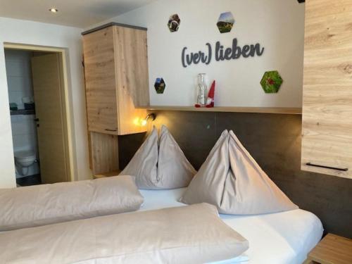 a bedroom with two white pillows on a bed at Haus Bergliebe in Schladming
