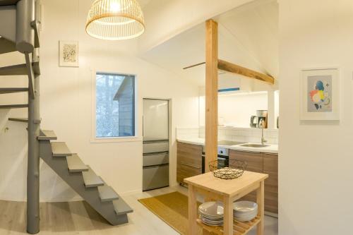 a kitchen with a staircase and a table in a room at Konayuki Cabin Hakuba - Vacation STAY 22044v in Hakuba