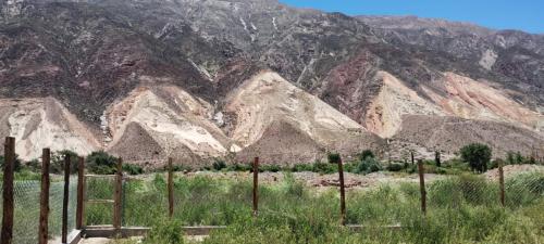 a mountain range with a fence in front of it at Alojamiento La Bonita de Maimará in Maimará