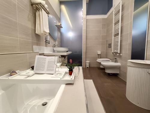a white bathroom with a sink and a toilet at Afrodite Guest House in Caserta
