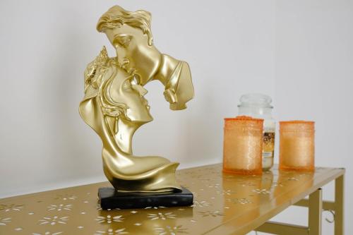 a gold statue sitting on top of a table at Afrodite Guest House in Caserta