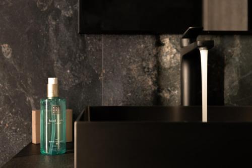 a bottle of soap sitting on top of a sink at Pleiades Urban Stay by Semavί in Heraklio Town