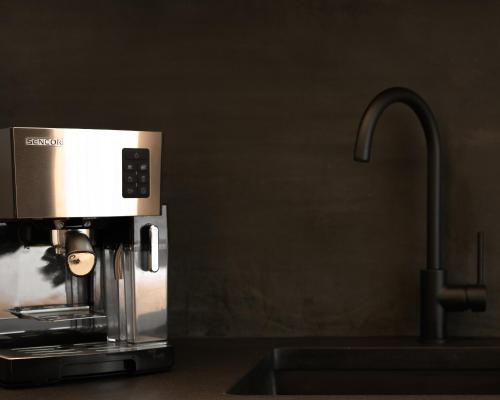 a coffee maker sitting on a counter next to a sink at Pleiades Urban Stay by Semavi in Heraklio Town