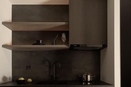 a kitchen with a sink and a stove at Pleiades Urban Stay by Semavί in Heraklio Town