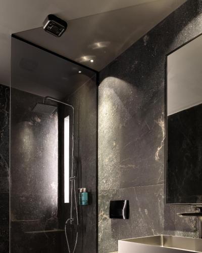 a bathroom with a shower with a sink and a mirror at Pleiades Urban Stay by Semavί in Heraklio Town