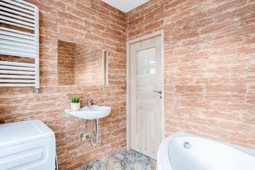 a bathroom with a white sink and a toilet at Hann Haven Apartments Ozimska 55 in Opole