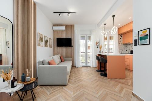 a living room with a couch and a kitchen at Oasis Diamond Suite in Thessaloniki