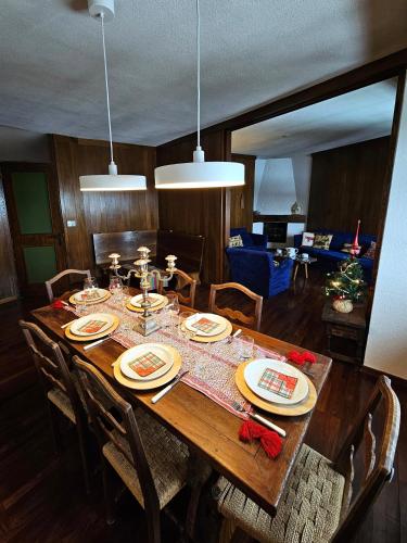 a wooden table with plates and napkins on it at Cervino 1865 - Family House in Breuil-Cervinia