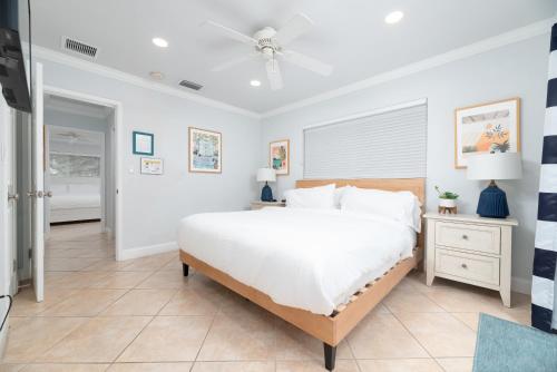 a bedroom with a large bed and a ceiling fan at Luxurious Fort Lauderdale Pool Home in Fort Lauderdale