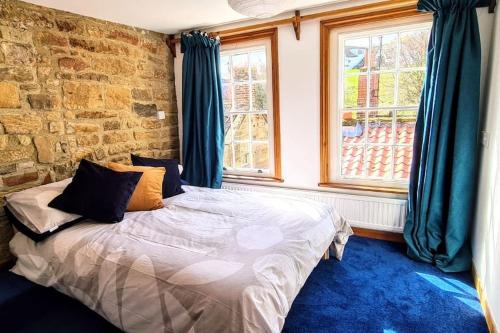 Ένα ή περισσότερα κρεβάτια σε δωμάτιο στο Bramblewick Cottage