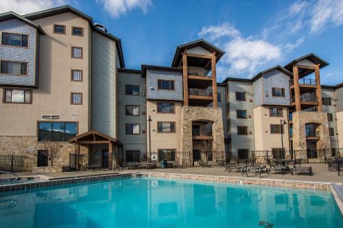 a hotel with a swimming pool in front of a building at Silverado Lodge by All Seasons Resort Lodging in Park City