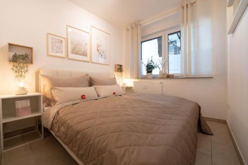 a bedroom with a large bed and a window at Balance: Wohnung - Zentral - Messe - Stadion in Dortmund