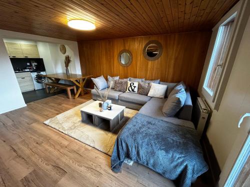 a living room with a couch and a table at SNOW NEST: Superbe cocon enneigé in Crans-Montana