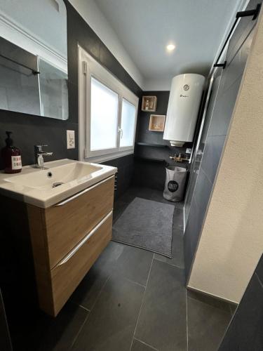 a bathroom with a sink and a window at SNOW NEST: Superbe cocon enneigé in Crans-Montana
