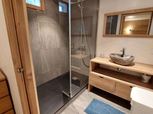 a bathroom with a shower with a sink and a mirror at Chalet rénové 3 chambres, proche centre Courchevel - FR-1-514-25 in le Praz