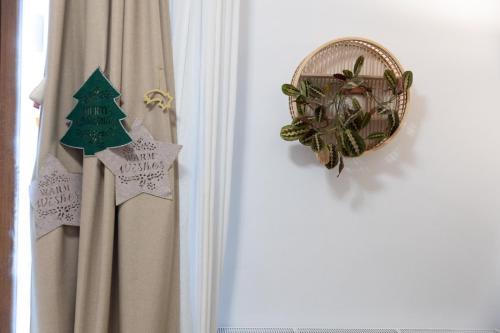 a christmas decoration on a wall next to a curtain at Sweet cozy Ultracentral in Craiova
