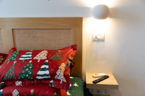 a bedroom with a bed with a christmas quilt at Sweet cozy Ultracentral in Craiova