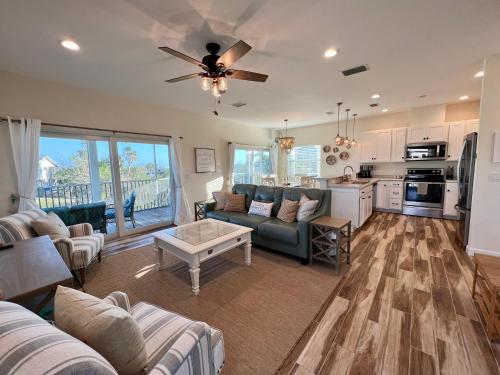 a living room with a couch and a table at Family Tides on LGI - Golf Cart Included in Placida