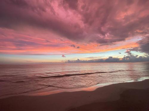 a sunset over the ocean with a sandy beach at Family Tides on LGI - Golf Cart Included in Placida