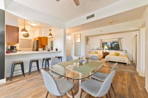 a living room with a dining room table and a bedroom at Hilton Pool Pass Included - Luxe Villa in Waikoloa