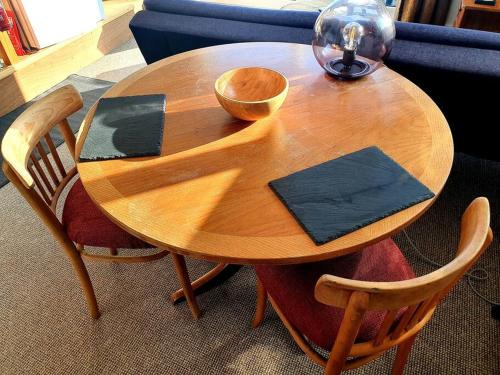 a wooden table with chairs and a bowl on it at The Studio at Stoodley Pike View in Todmorden