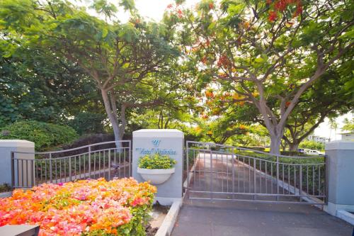 a bunch of flowers next to a fence at Hilton Pool Pass Included - Luxe Villa in Waikoloa