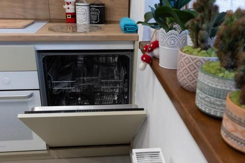 an oven with dishes inside of it in a kitchen at Sweet cozy Ultracentral in Craiova