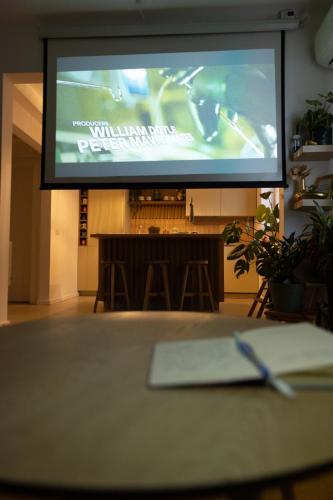a projection screen in a room with a table at Sweet cozy Ultracentral in Craiova