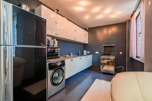 a kitchen with a washing machine in a kitchen at Cabernet Corner in Tbilisi City