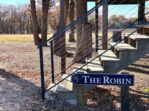 a sign that says the raisin next to some stairs at The Robin Treehouse 15 MIN to Magnolia Baylor in Elm Mott