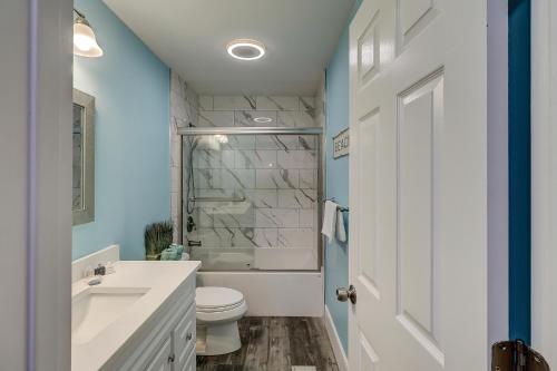 a bathroom with a white toilet and a sink at Luxury Updated 6 BR home Private Pool Near Ocean Bikes & Beach Gear Included in Hilton Head Island