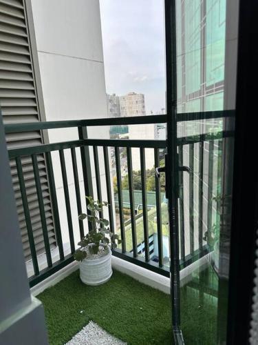 a balcony with a potted plant sitting on the grass at New & Spacious Unit in QC w/ Wifi & Netflix in Manila